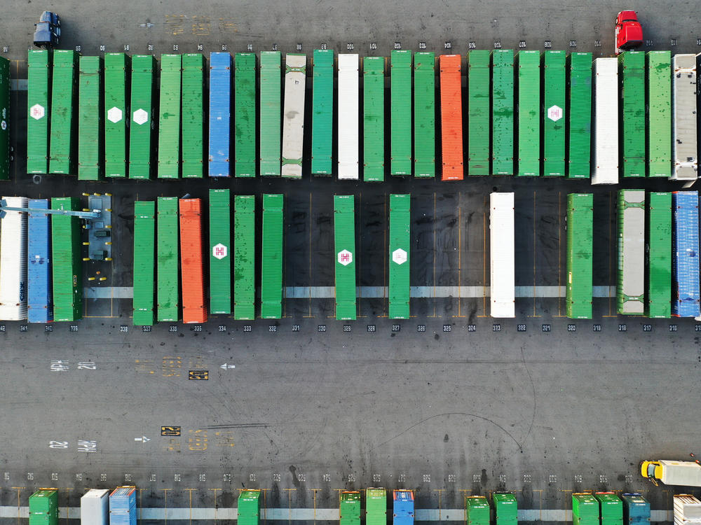 In an aerial view, shipping containers sit on truck transport chassis in a rail yard in Los Angeles on Oct. 22. Investors worry about the potential impact from omicron on already strained global supply chains.