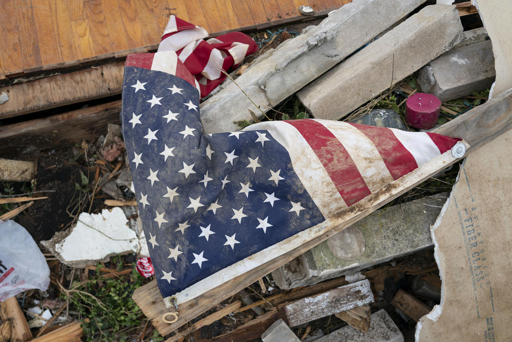 An American flag sits in the rubble of a home in Dawson Springs, Kentucky.