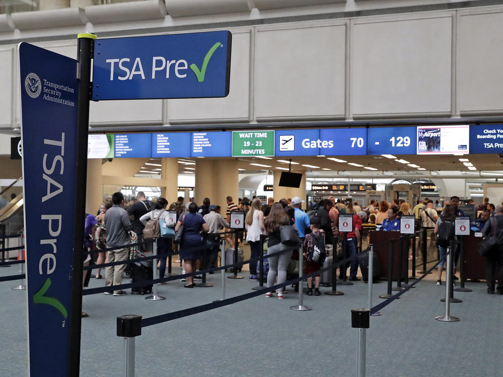 Air passengers heading to their departure gates enter TSA PreCheck at Orlando International Airport. Access to PreCheck could now be revoked for unruly passengers.