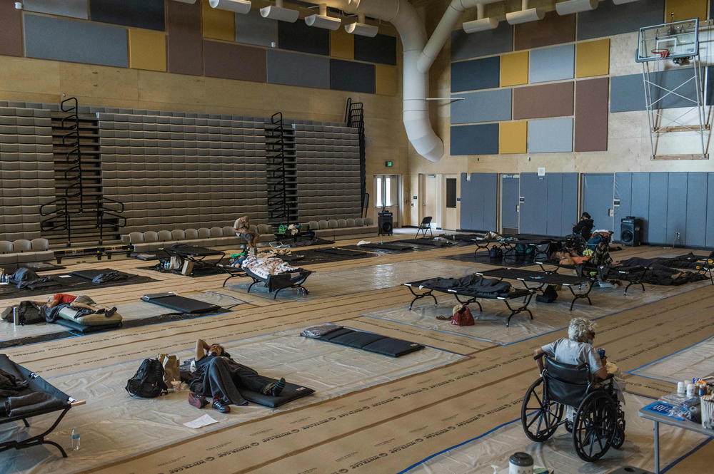 Residents spend the afternoon at a cooling center at Kellogg Middle School in Portland. Extreme heat triggered a public health emergency in the Pacific Northwest. Thousands went to the hospital and <a href=