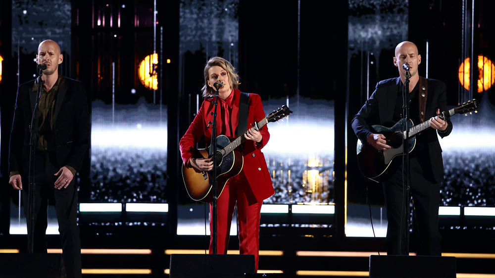 Brandi Carlile (center) performs with her longtime collaborators Phil Hanseroth (left) and Tim Hanseroth, at the 2021 Rock & Roll Hall of Fame Induction Ceremony on October 30, 2021 in Cleveland, Ohio.