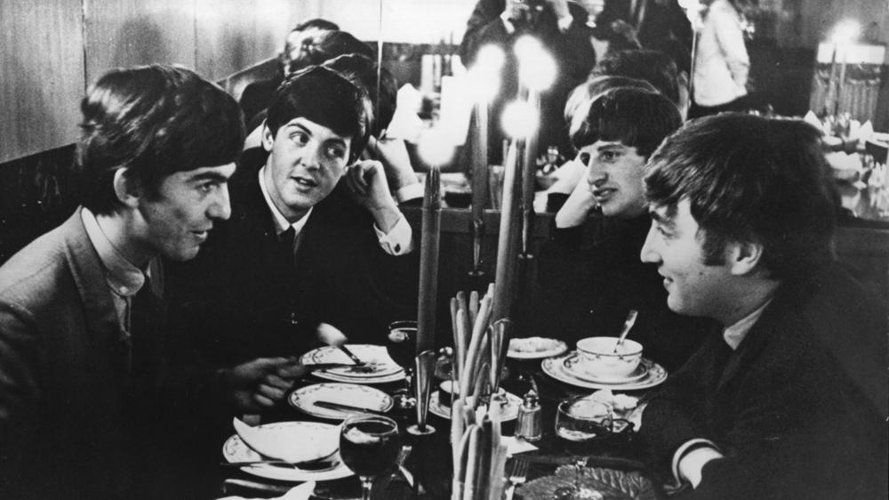 The Beatles, dining together in London in 1963.