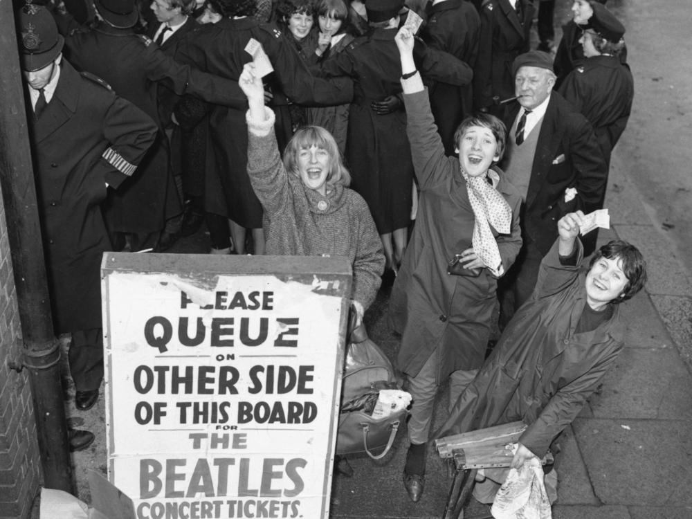Fans in London hold tickets for a Beatles concert in November 1963.