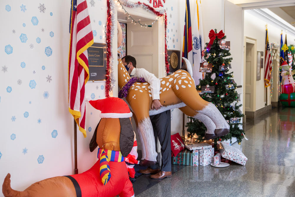 Rep. Crow brings an inflatable reindeer into his office. The reindeer belongs to Rep. Gallagher's office.