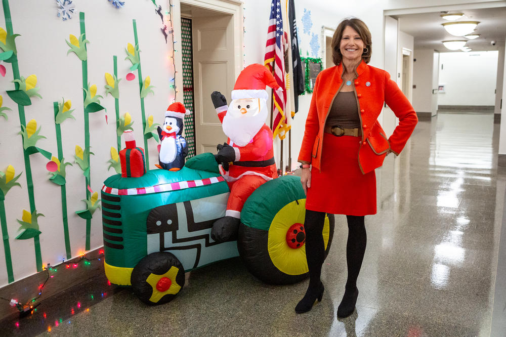 Democratic Rep. Cheri Bustos of Illinois has an inflatable Santa driving a John Deere tractor outside her office. The wall is adorned with paper cornstalks and snowflakes.