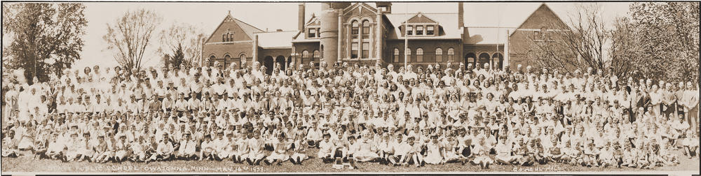 Children and staff stand in front of the Minnesota State Public School for Dependent and Neglected Children administration building in 1938.