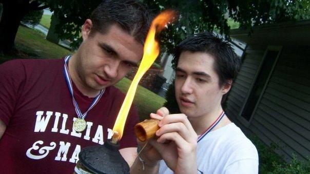 Andrew (left) and Joshua Cunningham (right) light the torch for the opening ceremony of the 2008 