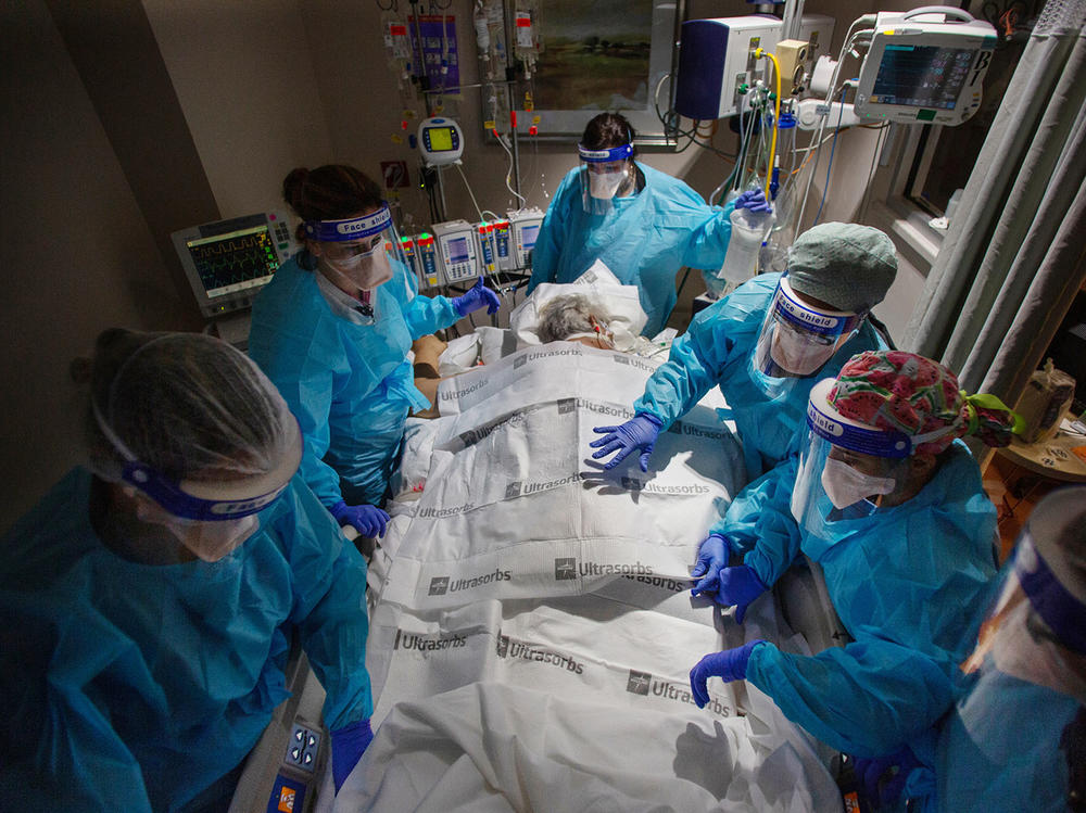 A team of nurses, patient care technicians and a respiratory therapist prepare to return a COVID patient to their back after 24 hours of lying on their stomach. That posture makes it easier to breathe and is a critical part of treatment for COVID patients in hospitals.
