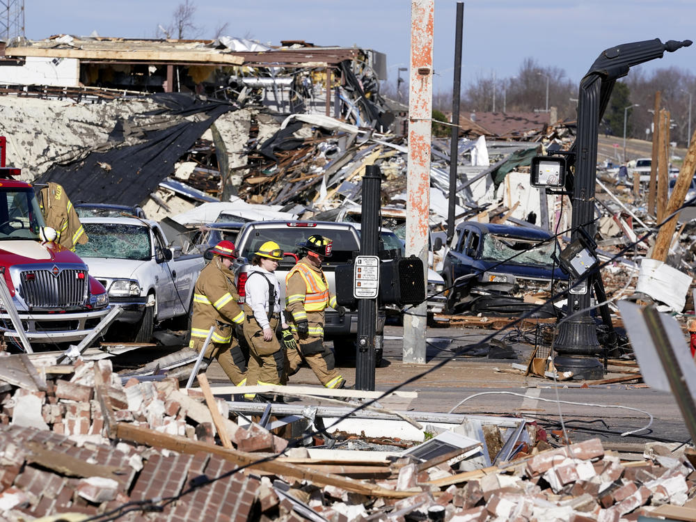Authorities on Saturday survey damage from a tornado in Mayfield, Ky.
