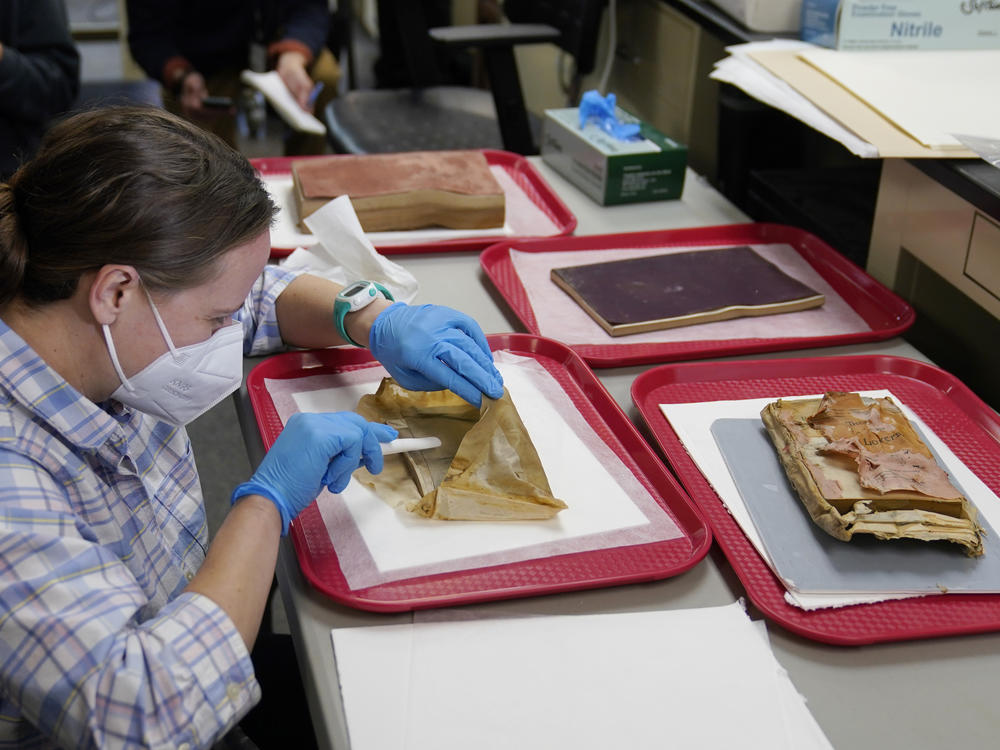 Sue Donovan, conservator for Special Collections at the University of Virginia, works on an envelope that was removed from a time capsule that was removed from the pedestal that once held the statue of Confederate General Robert E. Lee.