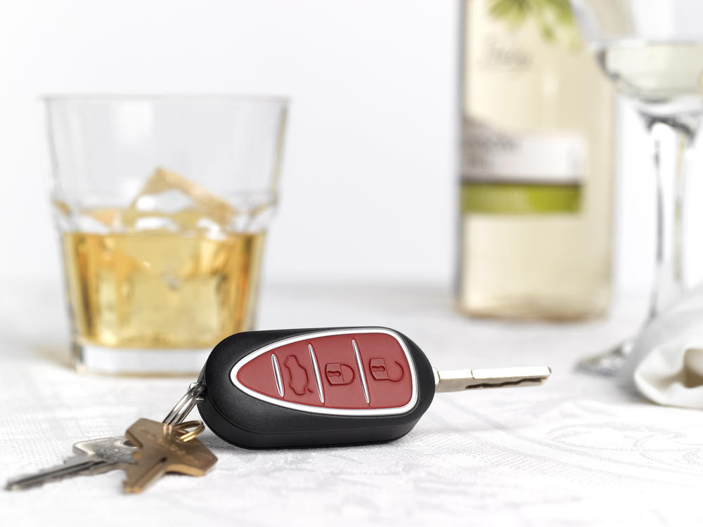 Car keys are shown by glasses with alcohol in this stock photo illustration. Companies are developing technology that would allow cars to stop people from driving when drunk.
