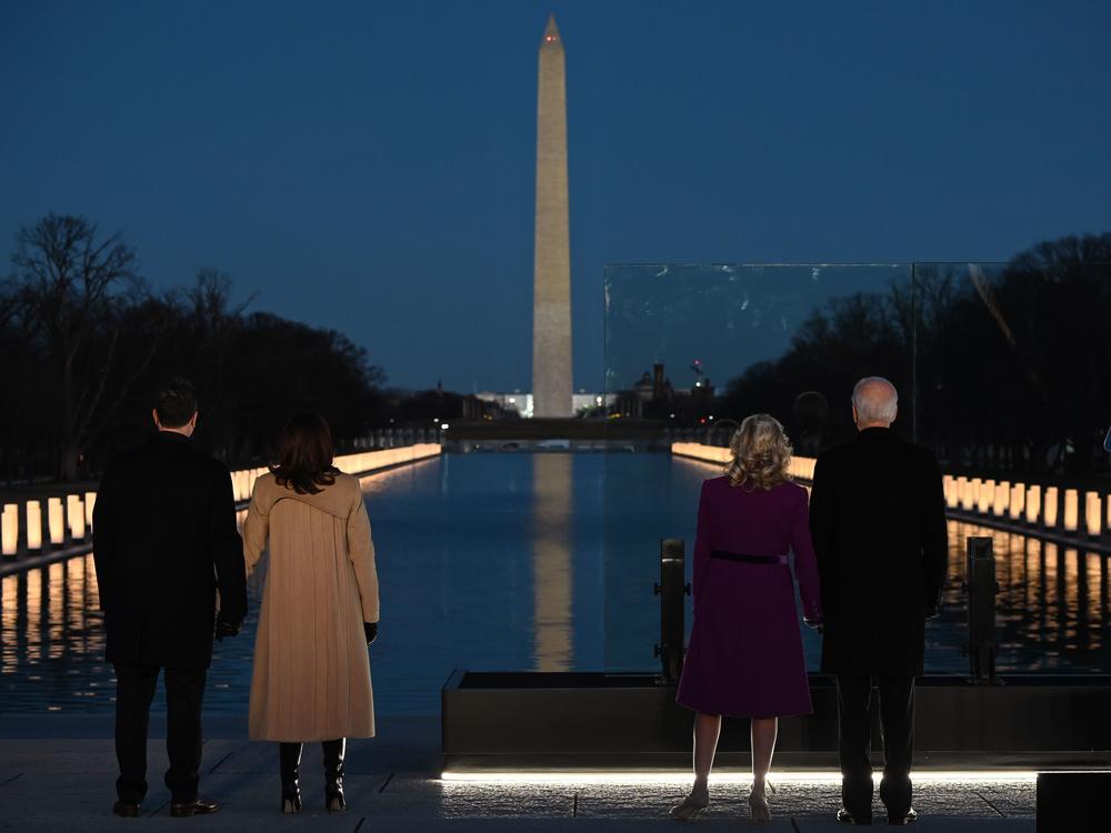 The night before his inauguration, Joe Biden (right) held a memorial for people who had died from COVID-19 at the Lincoln Memorial.