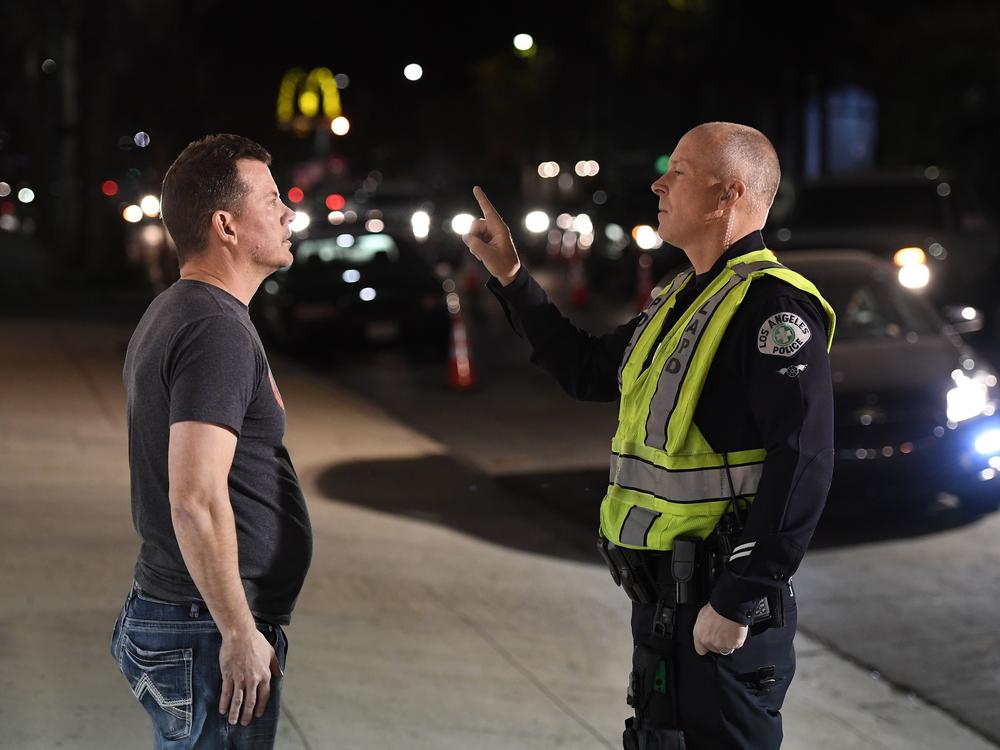 A man undergoes a sobriety test at a LAPD police DUI checkpoint in Reseda, Los Angeles, on April 13, 2018. A new federal law will eventually require new vehicles to detect and prevent drunk driving, which would revolutionize vehicle safety.