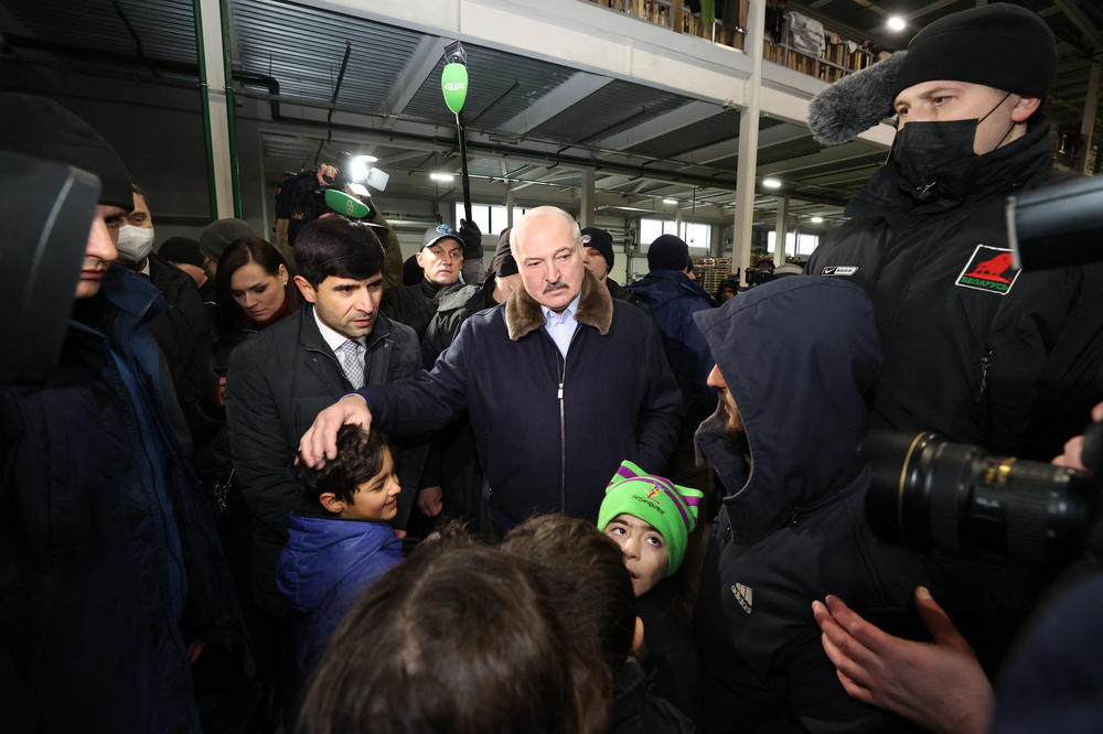 Belarusian President Alexander Lukashenko visits a center for migrants who remain in the country after attempting to cross into the EU via the Polish border, near Belarus' Bruzgi border point on the Belarusian-Polish border in the Grodno region on Nov. 26.