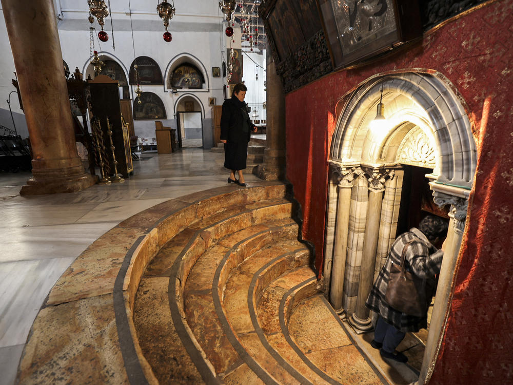 A handful of visitors tour the Church of the Nativity, traditionally believed to be the birthplace of Christ, in the biblical West Bank city of Bethlehem, on Dec. 15.