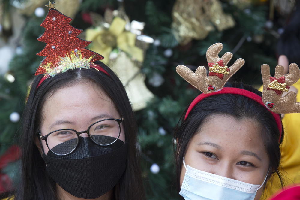 Women wearing masks to curb the spread of the coronavirus work on decorations to celebrate Christmas at a church in Bali, Indonesia, on Friday.