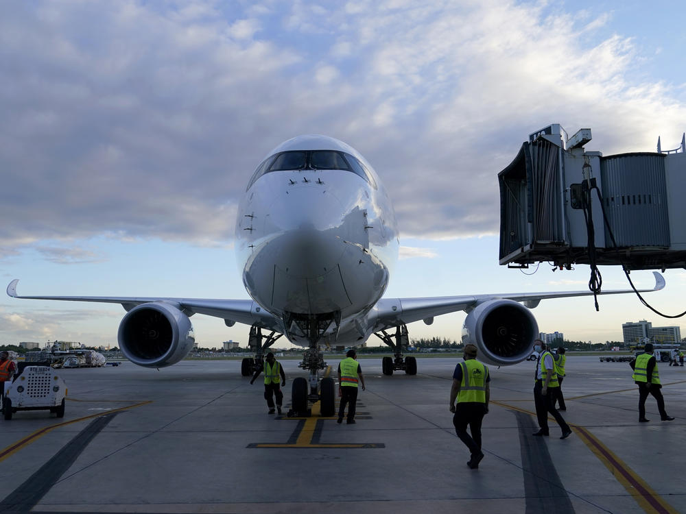 A Lufthansa flight arrives at Miami International Airport last month. The German airline, along with United and Delta, reported canceling dozens of Christmas Eve departures as illnesses tied to the omicron variant of COVID-19 take a toll on flight crew.