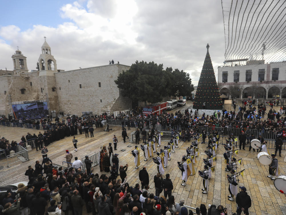 Palestinian scout bands parade through Manger Square at the Church of the Nativity, traditionally believed to be the birthplace of Jesus Christ, during Christmas celebrations, in the West Bank town of Bethlehem on Friday.