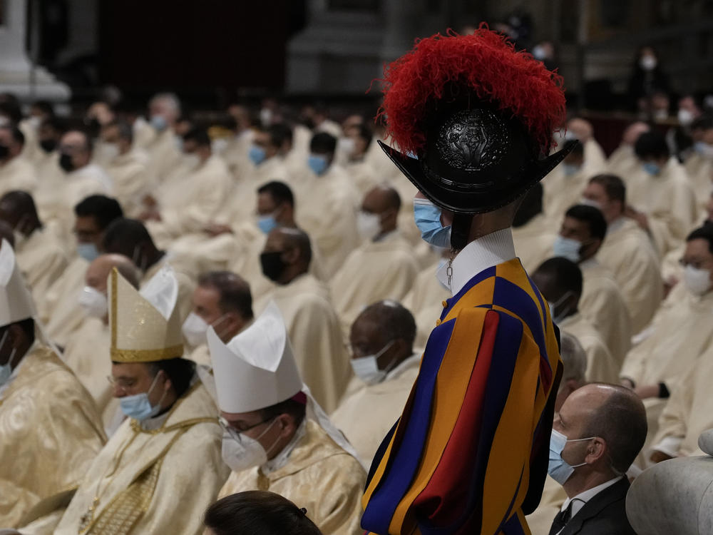 A Swiss Guard stands as Pope Francis celebrates Christmas Eve Mass at St. Peter's Basilica.