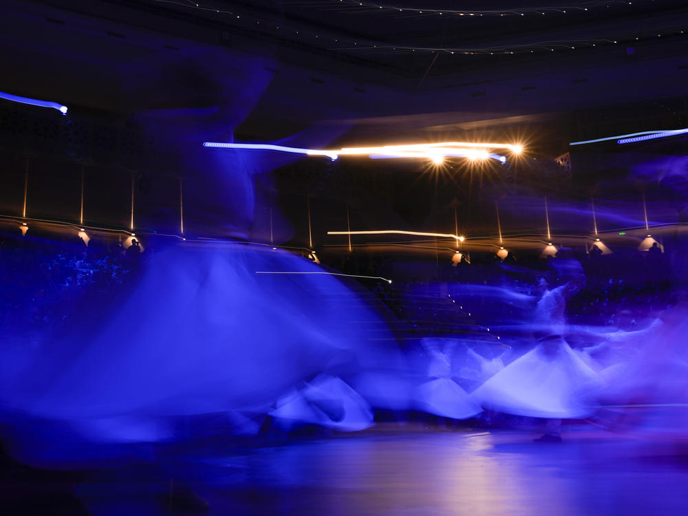 Whirling dervishes perform during the ceremony.