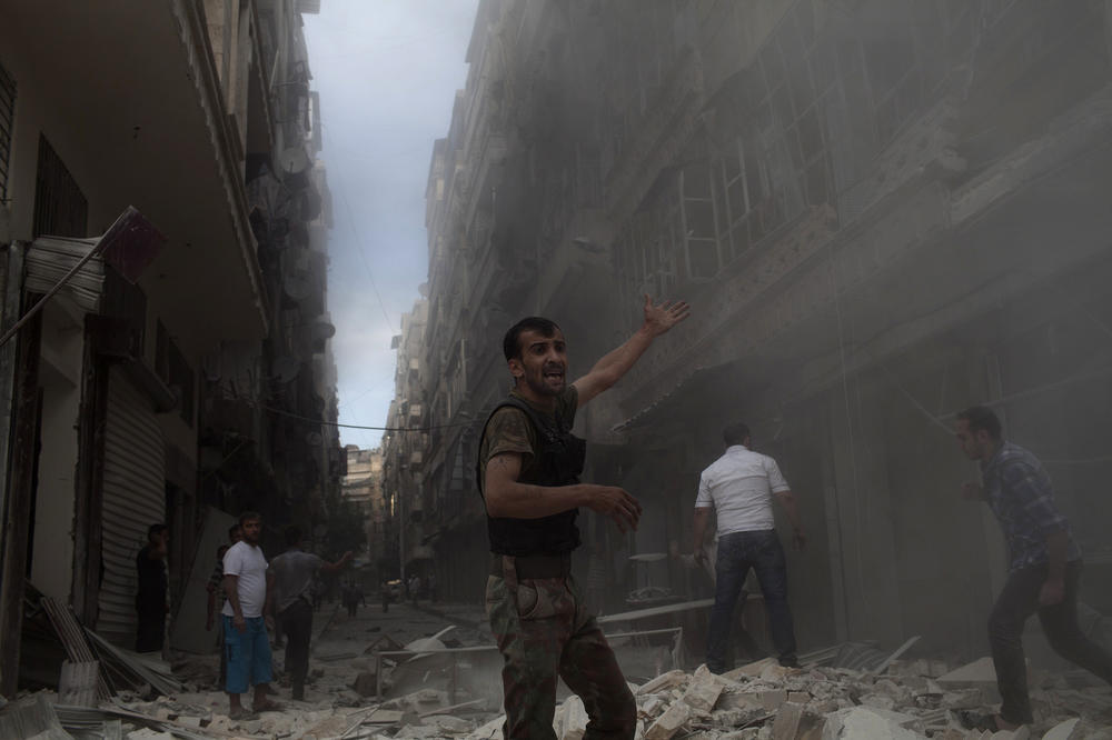 Syrian men gather amid the rubble of the Nur al-Shuhada mosque, which was shelled by forces loyal to Syrian President Bashar Assad, on Oct. 17, 2012, in the Shaar district of Aleppo.