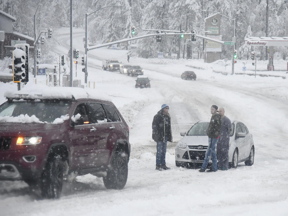 Stuck motorists are seen along Brunswick Road as heavy snow continues to fall early Monday, in Grass Valley, Calif.