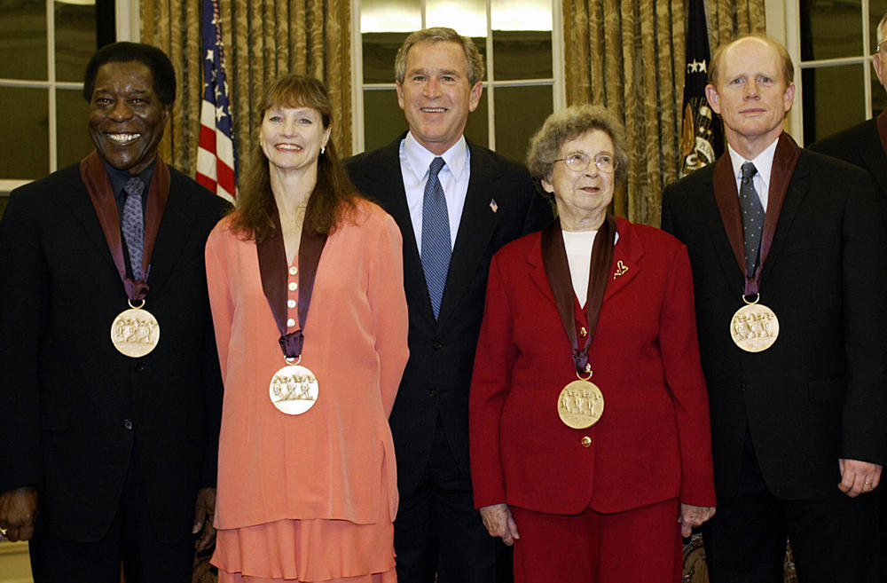 Beverly Cleary, in red, with President George W. Bush and other recipients of the National Medal of Arts in the Oval Office of the White House, November 2003.