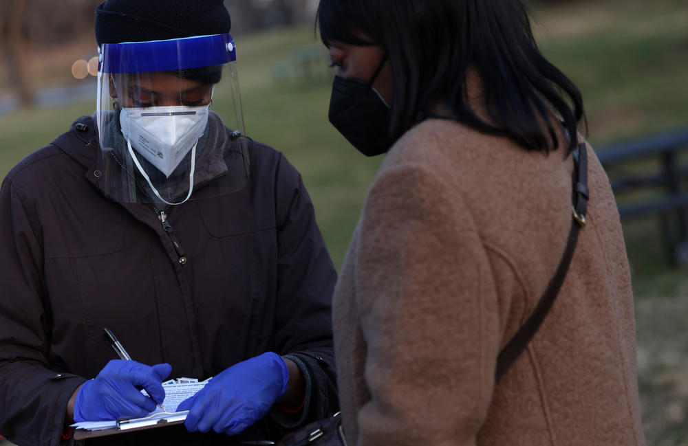 Nardos Amare checks in people at a COVID-19 testing site outside Benning Stoddert Recreation Center last week in Washington, D.C.