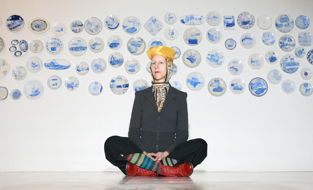 Artist Julie Green in front of a cluster of 