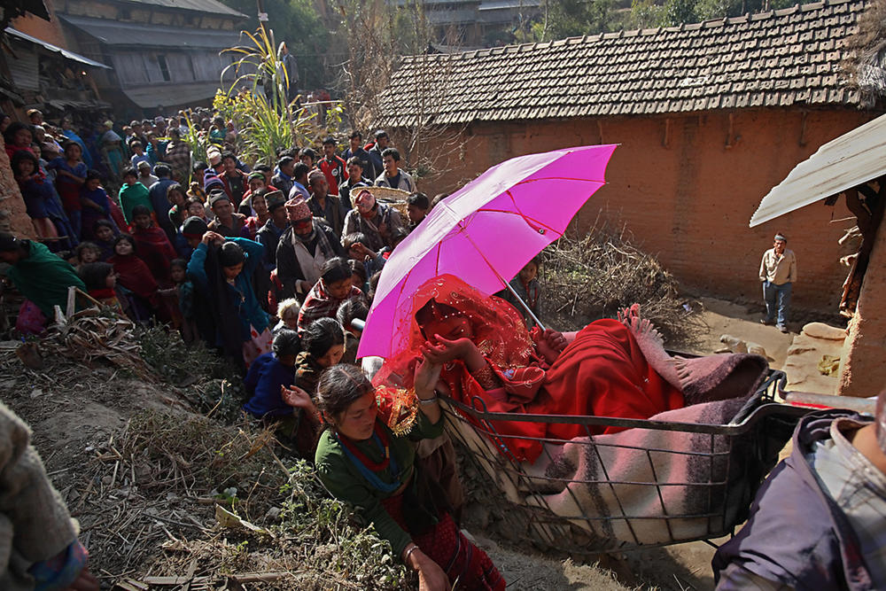 Sumeena, 13, is carried in a basket during her wedding to Prakash, 15, in 2007.