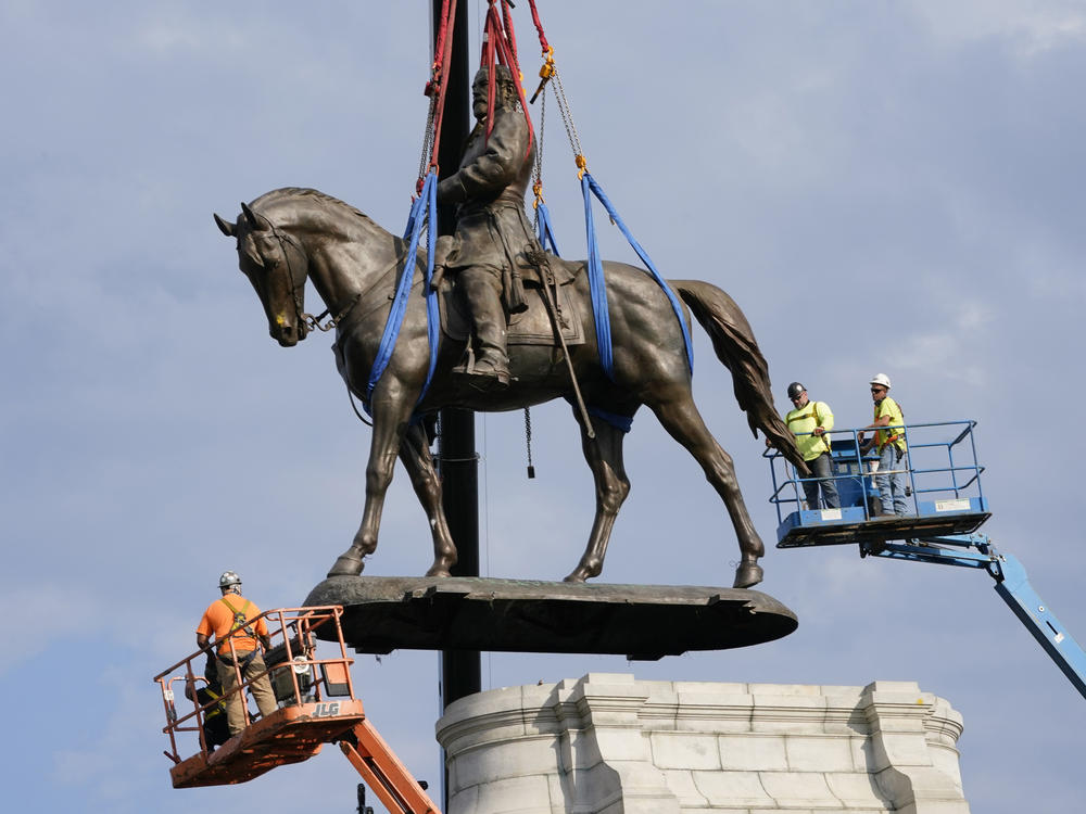 Crews remove the statue of Robert E. Lee in Richmond on Sept. 8. Pending city council approval, the statue and eight other Confederate monuments will be moved to Richmond's Black History Museum.