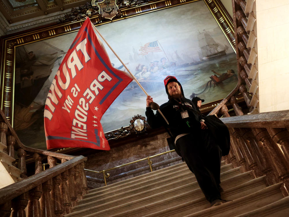 A protester holds a Trump flag inside the U.S. Capitol near the Senate Chamber.
