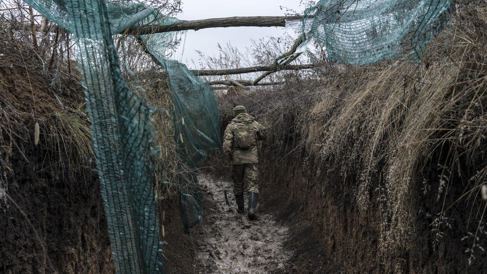 A Ukrainian soldier walks in a trench on the front line in Zolote, Ukraine, earlier this month. A buildup of Russian troops along the border with Ukraine has heightened worries that Russia intends to invade.