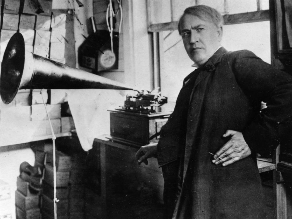 American inventor and businessman Thomas Edison with an Edison Standard Phonograph, at his lab in West Orange, New Jersey, 1906.
