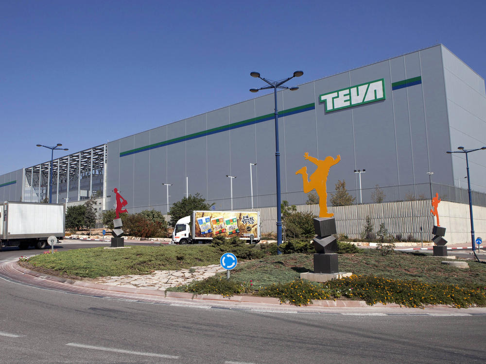 Trucks drive in front of Teva Pharmaceutical Logistic Center in the town of Shoam, Israel, on Oct. 16, 2013. On Thursday, a jury held Teva responsible for contributing to the opioid crisis.