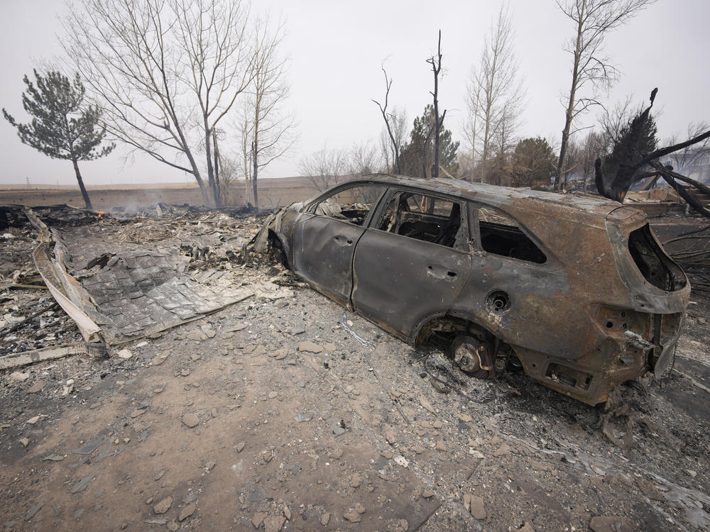 Damage to homes burned by wildfires after they ripped through a development are shown Friday in Superior, Colo.