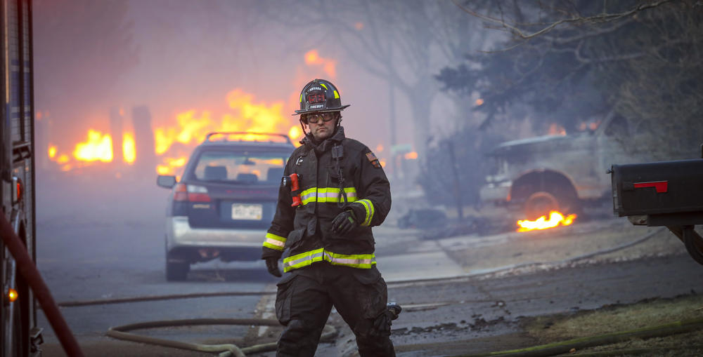 Dec. 30: Louisville, Colo. — An Arvada firefighter walks back to a firetruck as a fast-moving wildfire sweeps through the area in the Centennial Heights neighborhood.