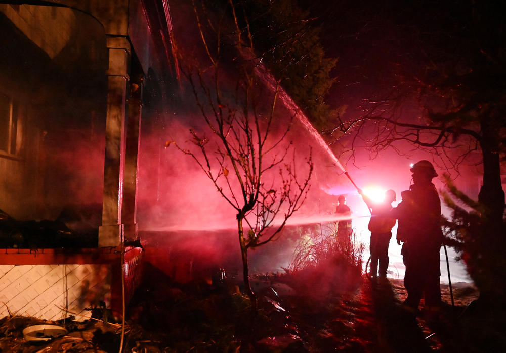 Dec. 31: Louisville, Colo. — Fire crews work to put out flames at a home burned in the Marshall Fire in Boulder County.