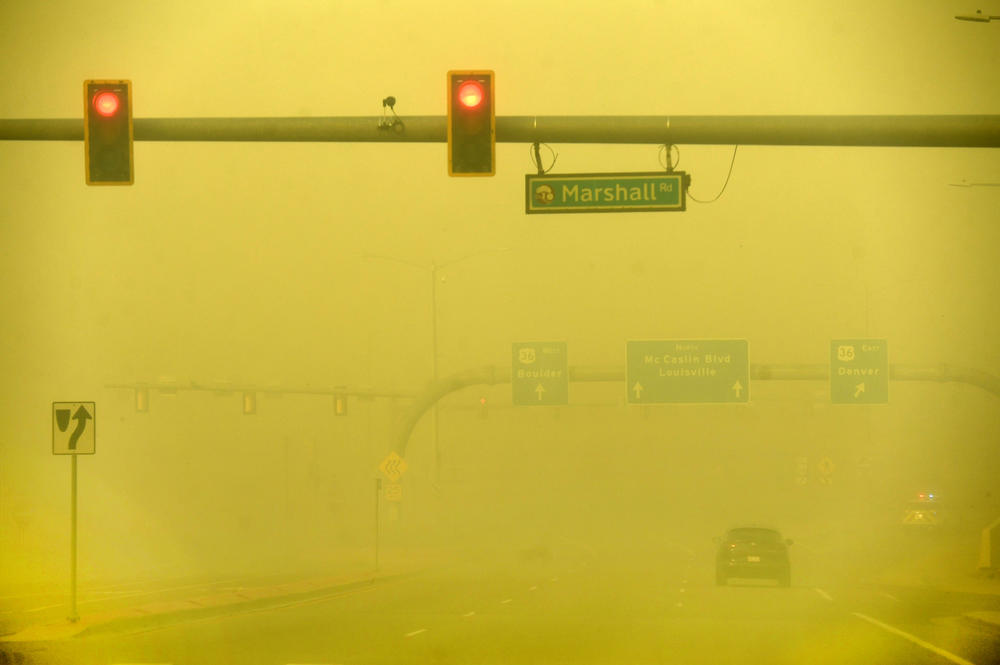 Dec. 30: Louisville, Colo. — A car makes its way down smoky, yellow skies along McCaslin Boulevard.