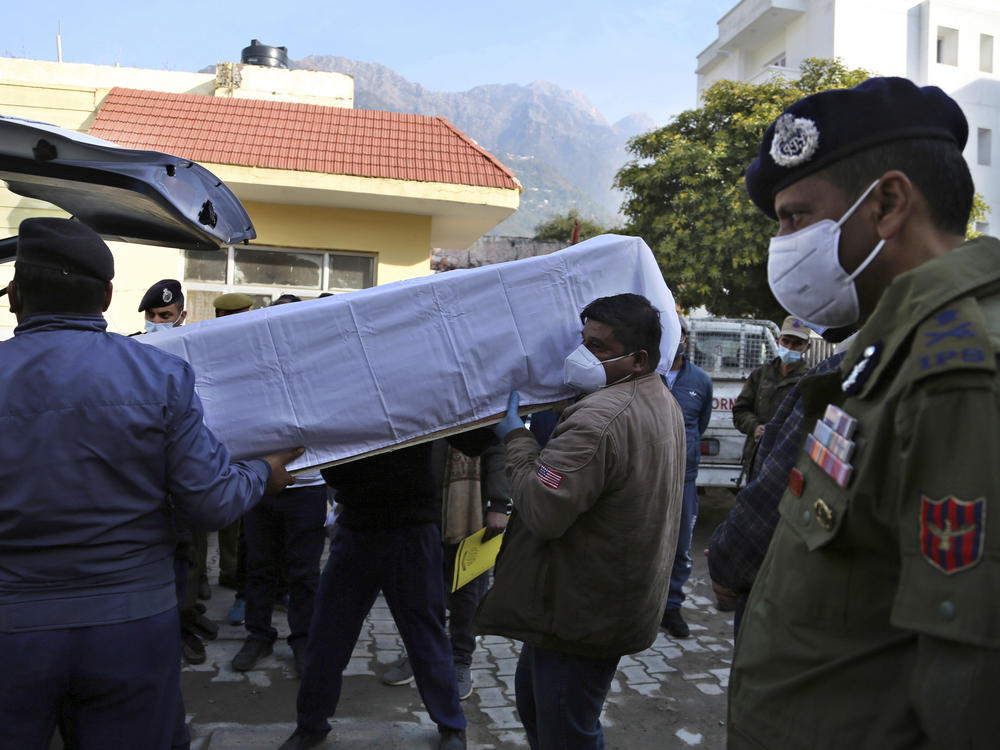 Health workers carry the coffin of a victim who died Saturday in a stampede at the Mata Vaishnav Devi shrine in Indian-controlled Kashmir.