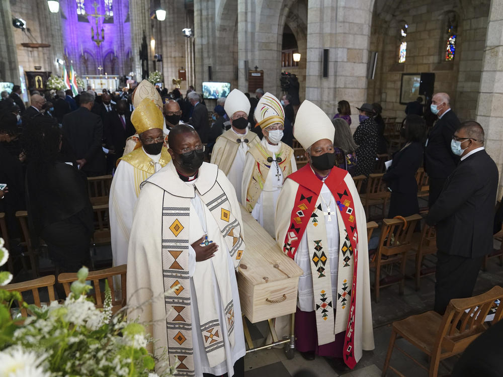 Desmond Tutu's coffin is carried out of the cathedral at the end of the funeral service.