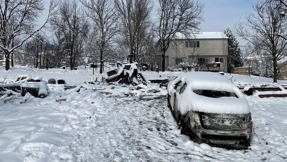 The remains of a home and a burned car are pictured in Superior, Colo. More than 300 homes in the town were destroyed.
