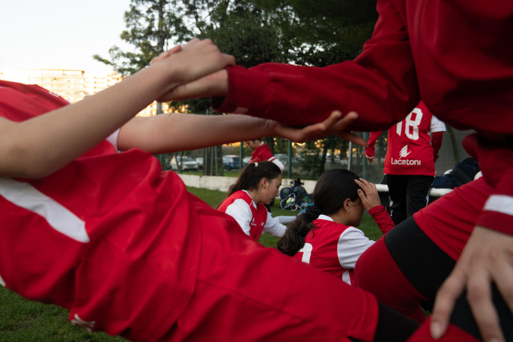 Girls help each other up during practice.