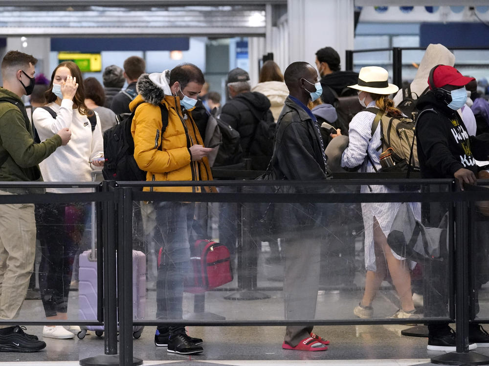 Travelers line up for flights at O'Hare International Airport in Chicago on Thursday.