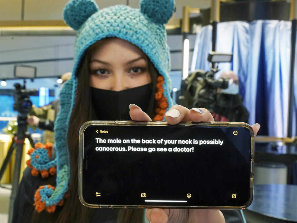 Nadia Popovici poses for a photo before Saturday's hockey game between the Seattle Kraken and the Vancouver Canucks, displaying the text of a message she showed Hamilton back in October.