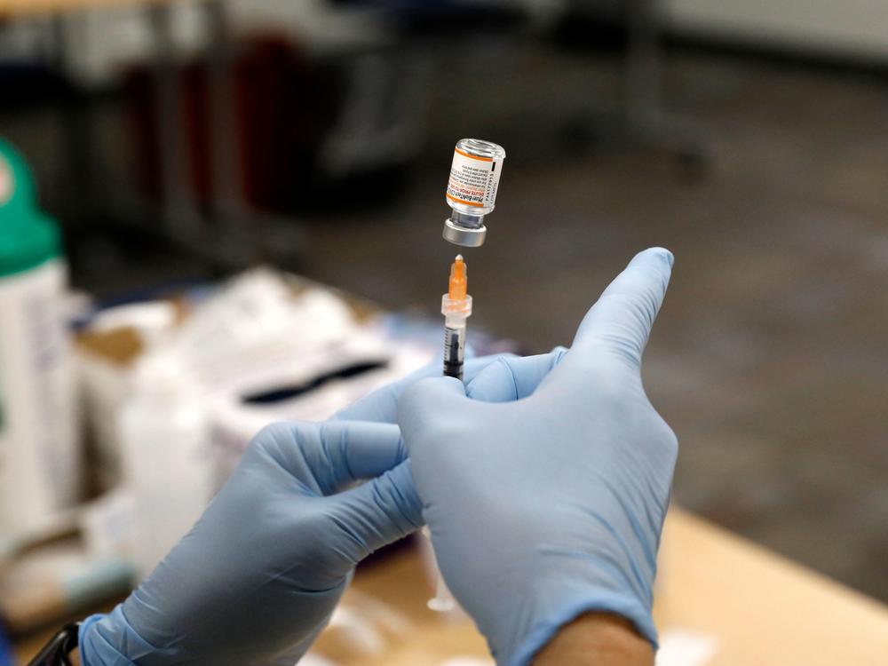 A nurse practitioner fills a syringe with the Pfizer COVID-19 vaccine at the Beaumont Health offices in Southfield, Mich., on Nov. 5.