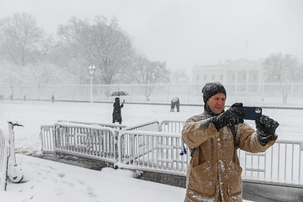 A man from New Orleans visiting Washington, D.C., takes a selfie during a snowstorm in front of the White House on Monday. A winter storm is bringing heavy snow to the Mid-Atlantic region on Monday.