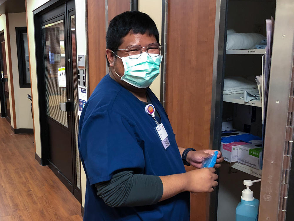 Pae Junthanam, a nurse from Thailand, grabs supplies from a closet in the intensive care unit at Billings Clinic.