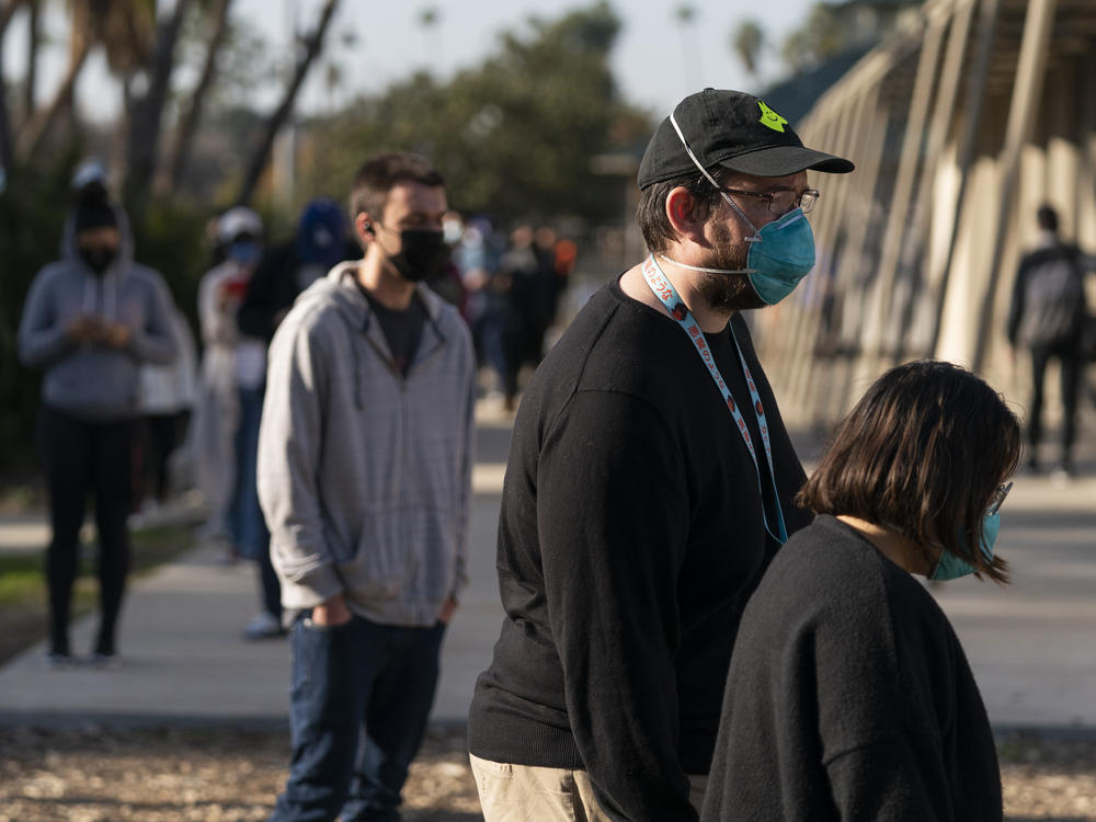 People wait in line for a coronavirus test in Los Angeles on Tuesday. California is starting to feel the full wrath of the omicron variant. Hospitalizations have jumped nearly 50% since Christmas and models show that in a month, the state could have 22,000 people in hospitals, which was the peak during last winter's epic surge.