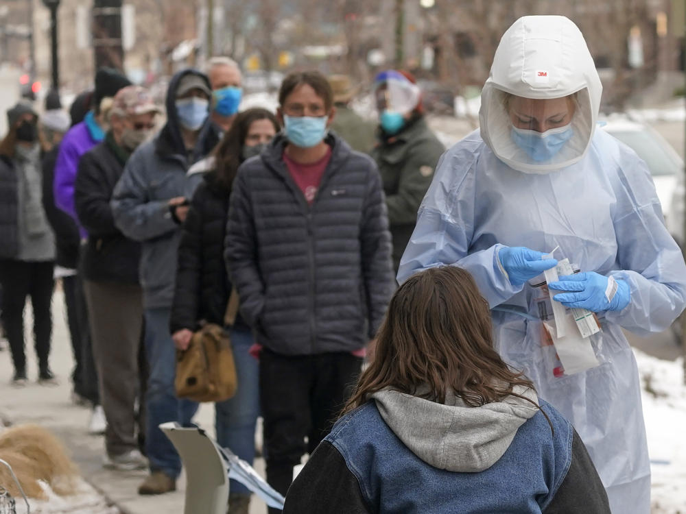 A member of the Salt Lake County Health Department COVID-19 testing staff performs a test outside the Salt Lake County Health Department on Tuesday in Salt Lake City.